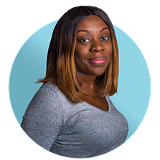 A woman smiling wearing a gray shirt